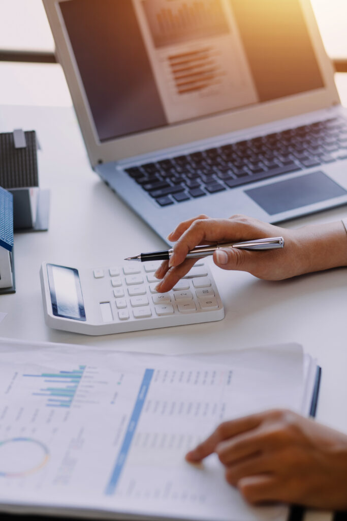 businessman working on desk office with using a calculator to ca