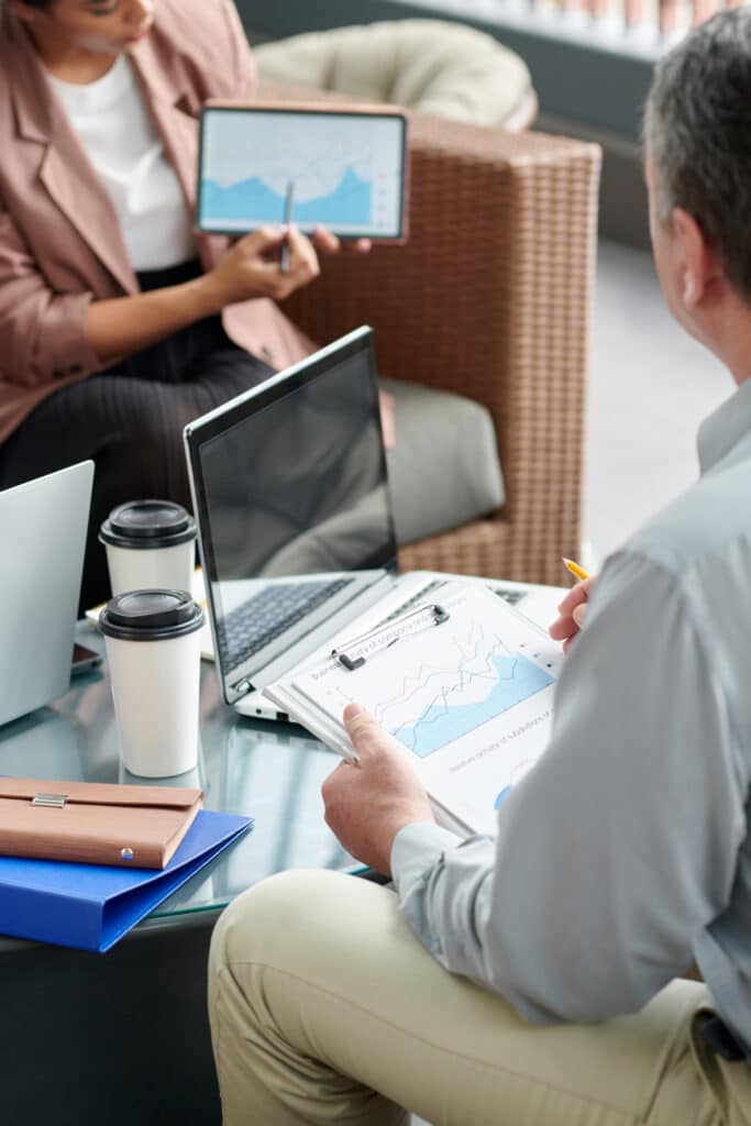 Businesswoman Explaining Data on Report